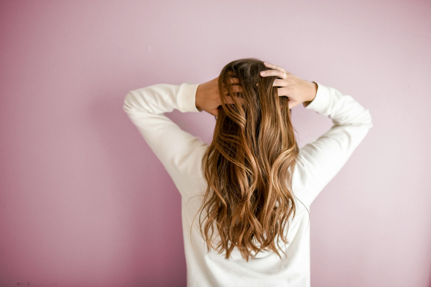 Stylist finishing a client's hair